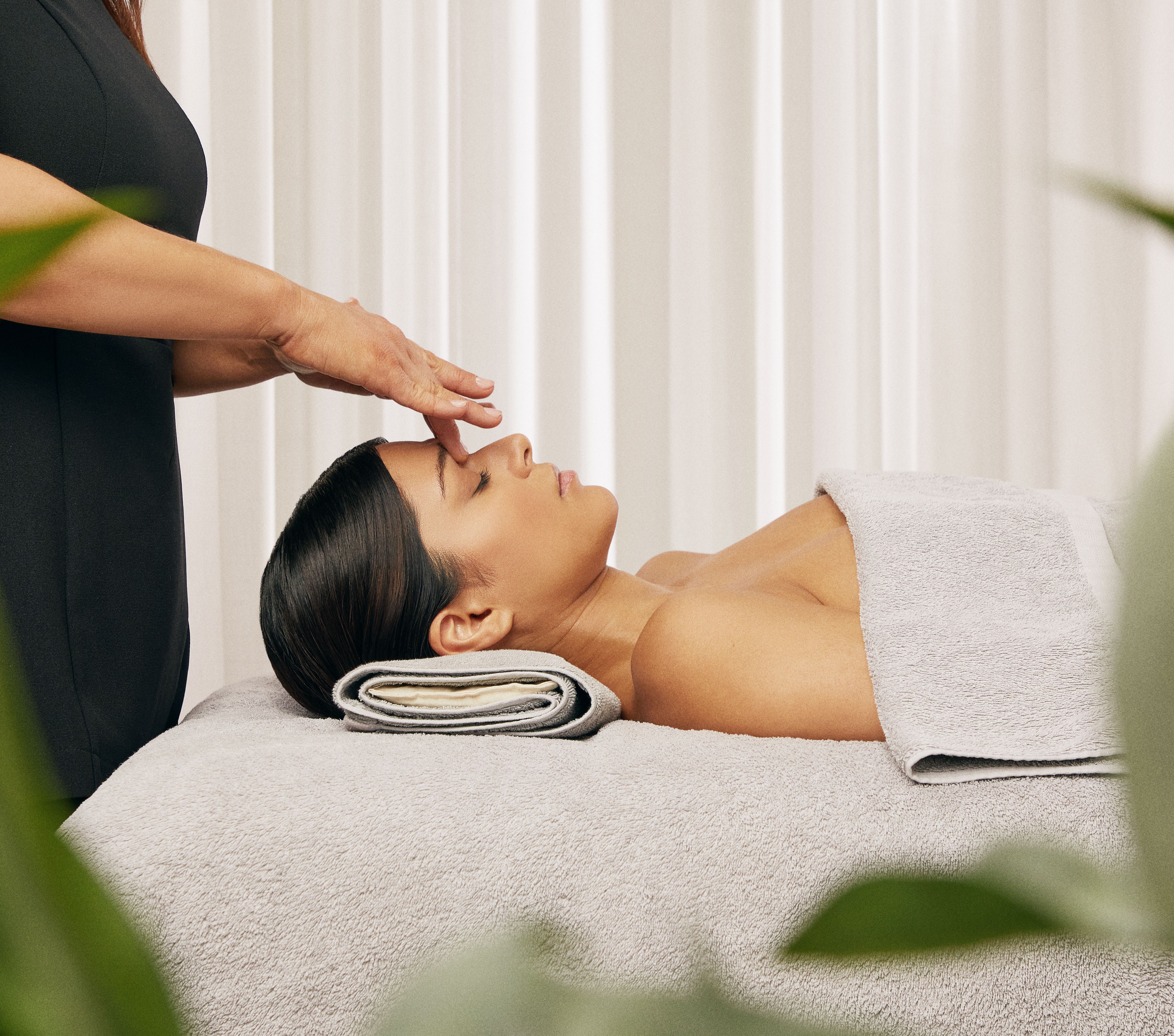 Person receiving a relaxing facial massage in a spa setting