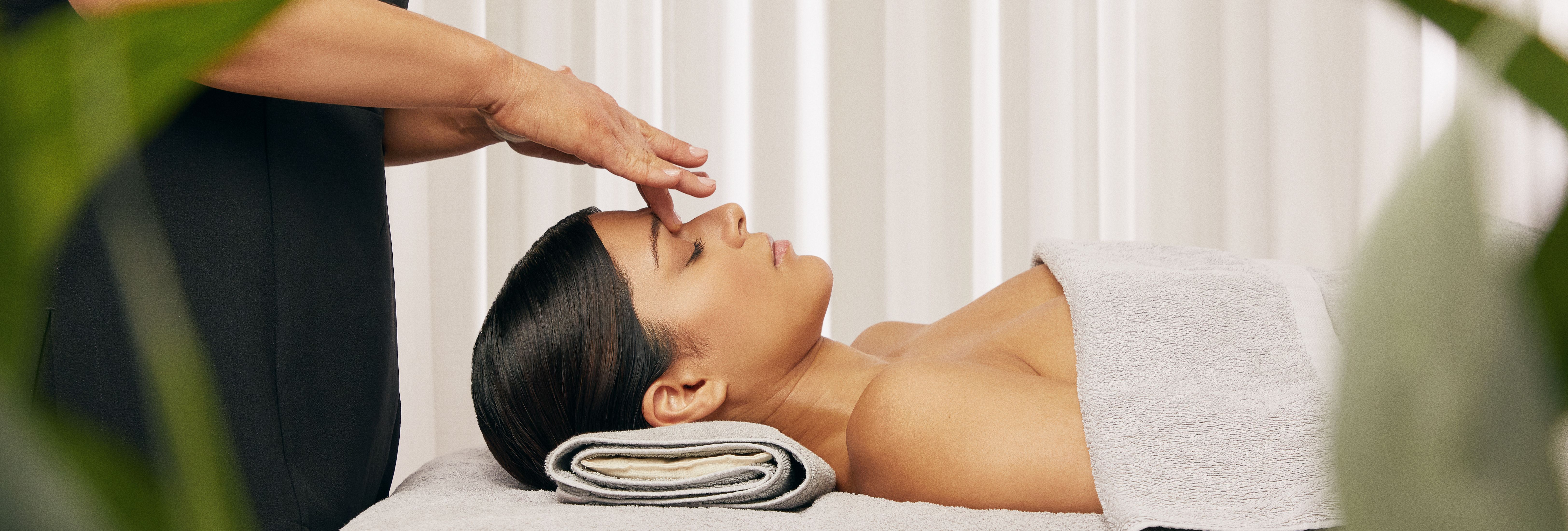 Person receiving a relaxing facial massage in a spa setting
