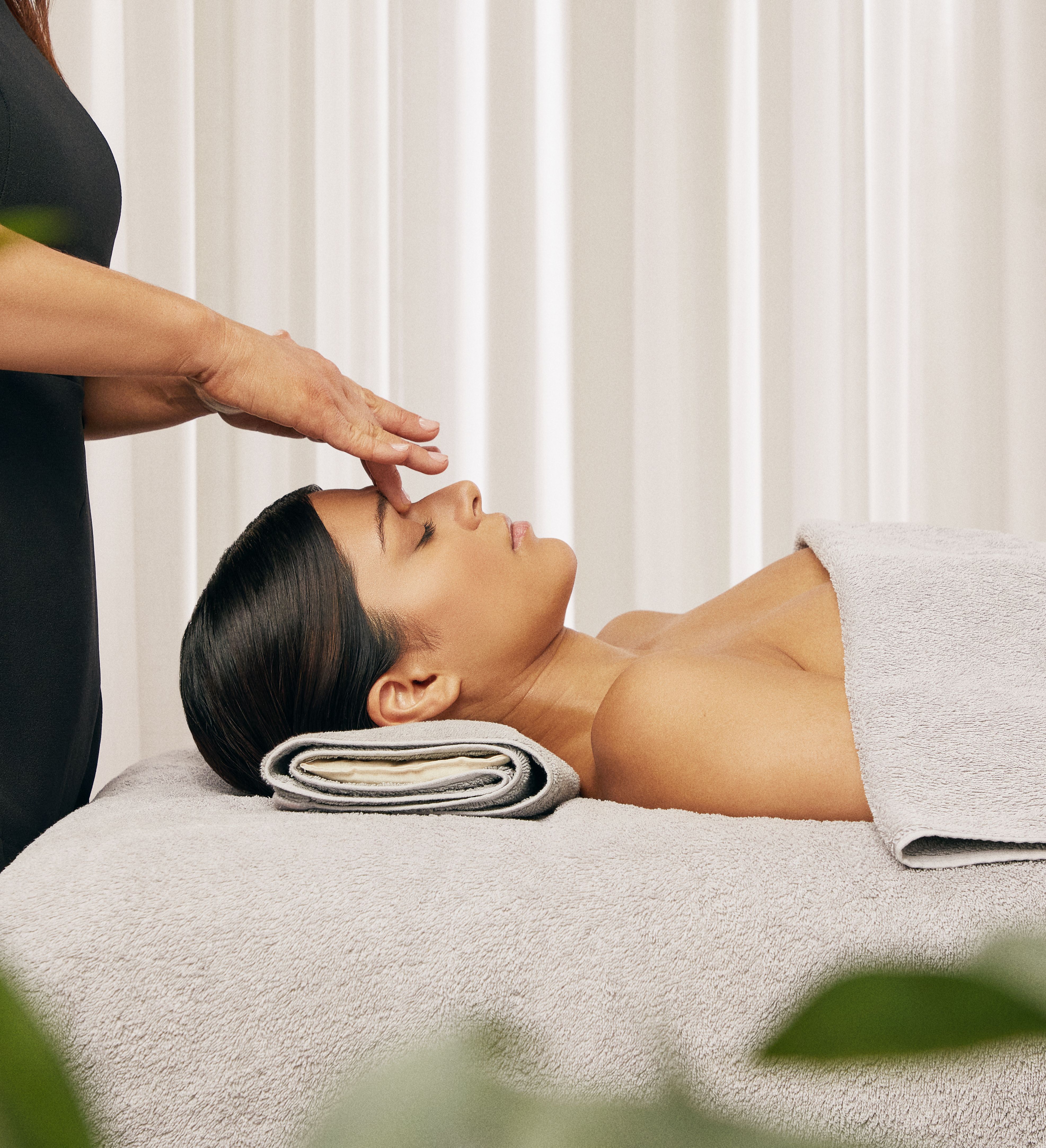Person receiving a relaxing facial massage in a spa setting