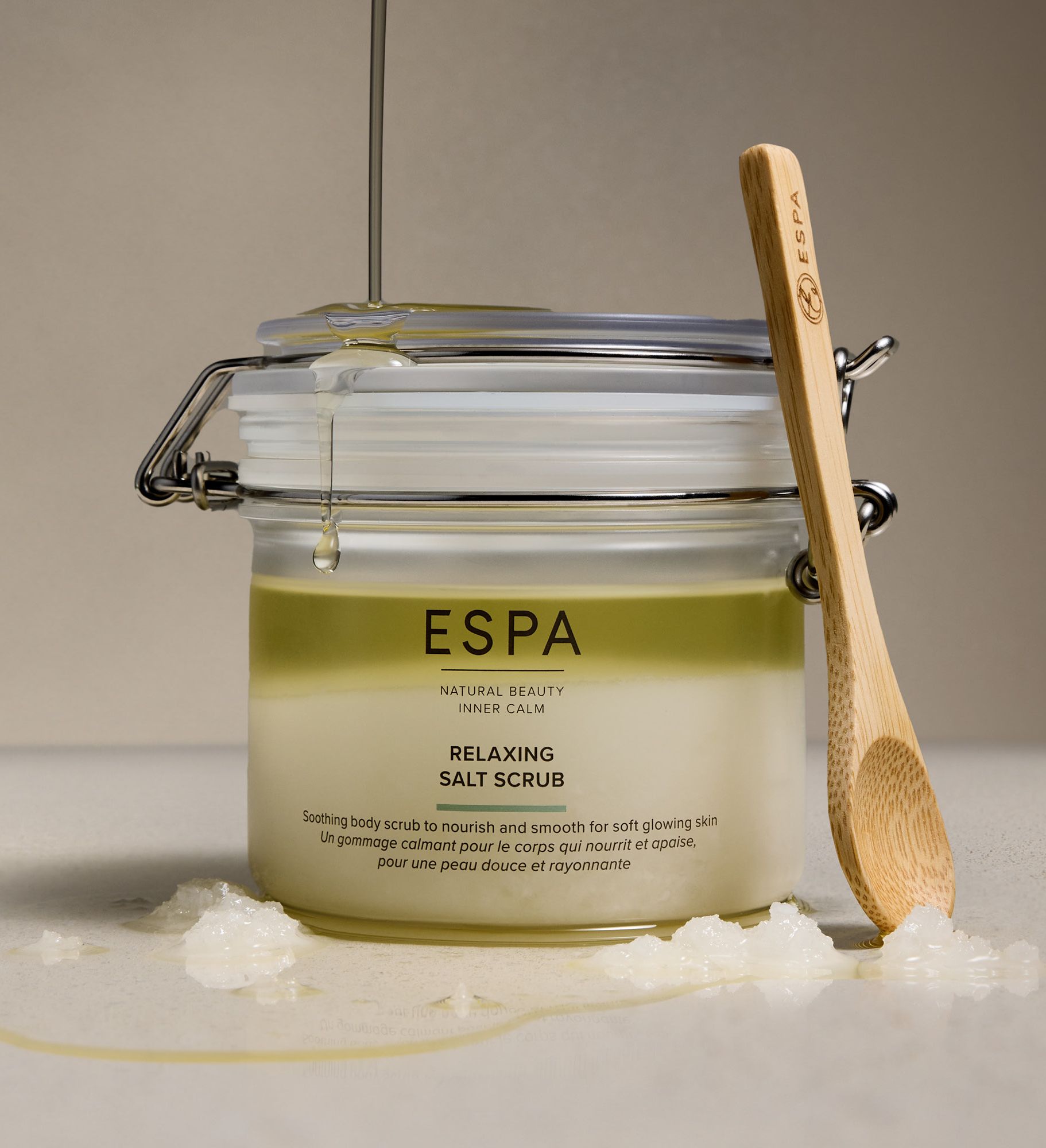 ESPA Relaxing Salt Scrub jar with wooden spoon and dripping oil