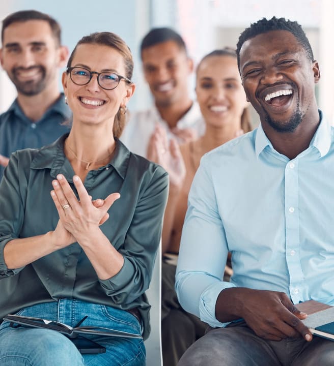 Group of people sat down laughing