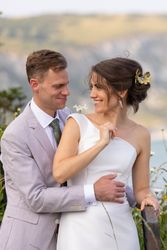 Bride and groom smiling at each other outdoors