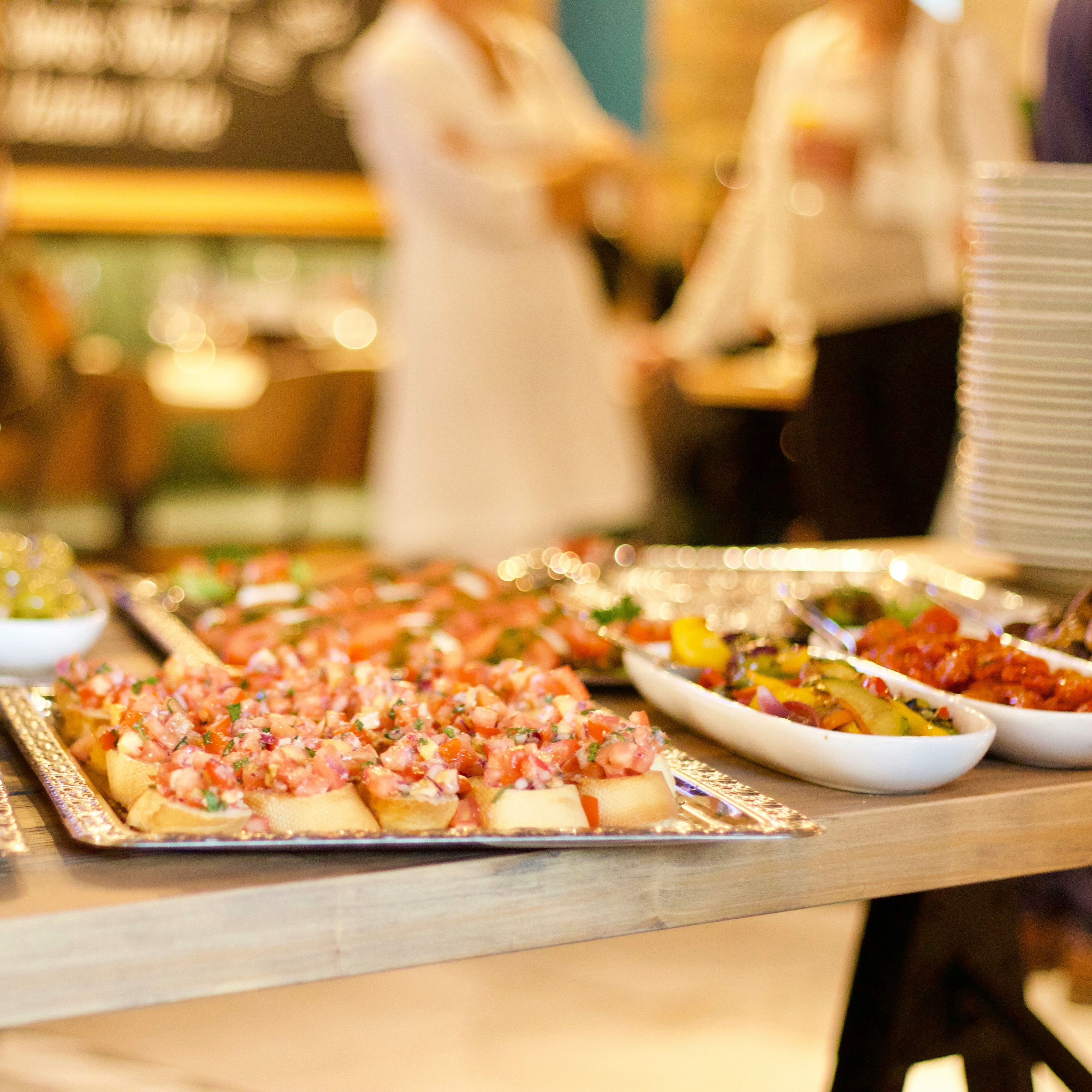 Buffet table with assorted appetizers and salads at a social event