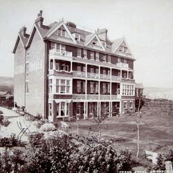 Historic photograph of the Grand Hotel in Swanage surrounded by gardens.