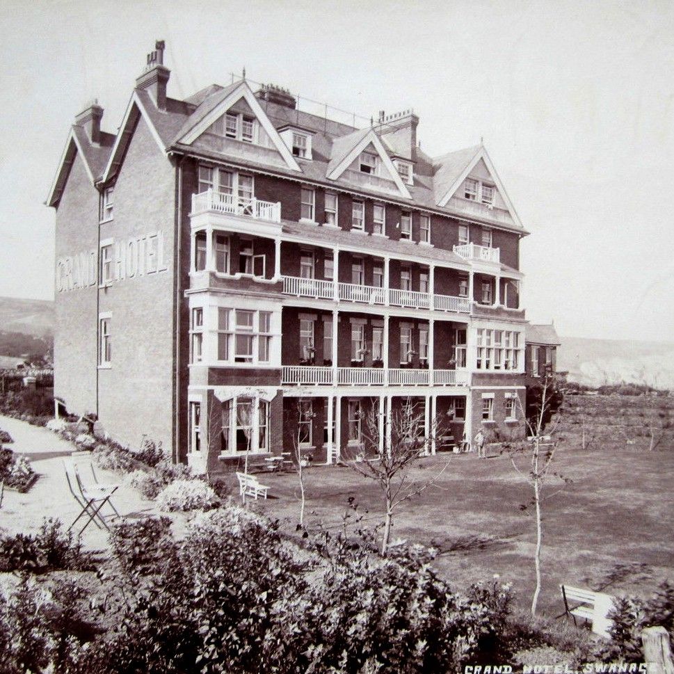 Historic photograph of the Grand Hotel in Swanage surrounded by gardens.