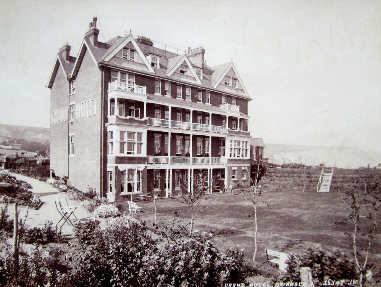Historic photograph of the Grand Hotel in Swanage surrounded by gardens.