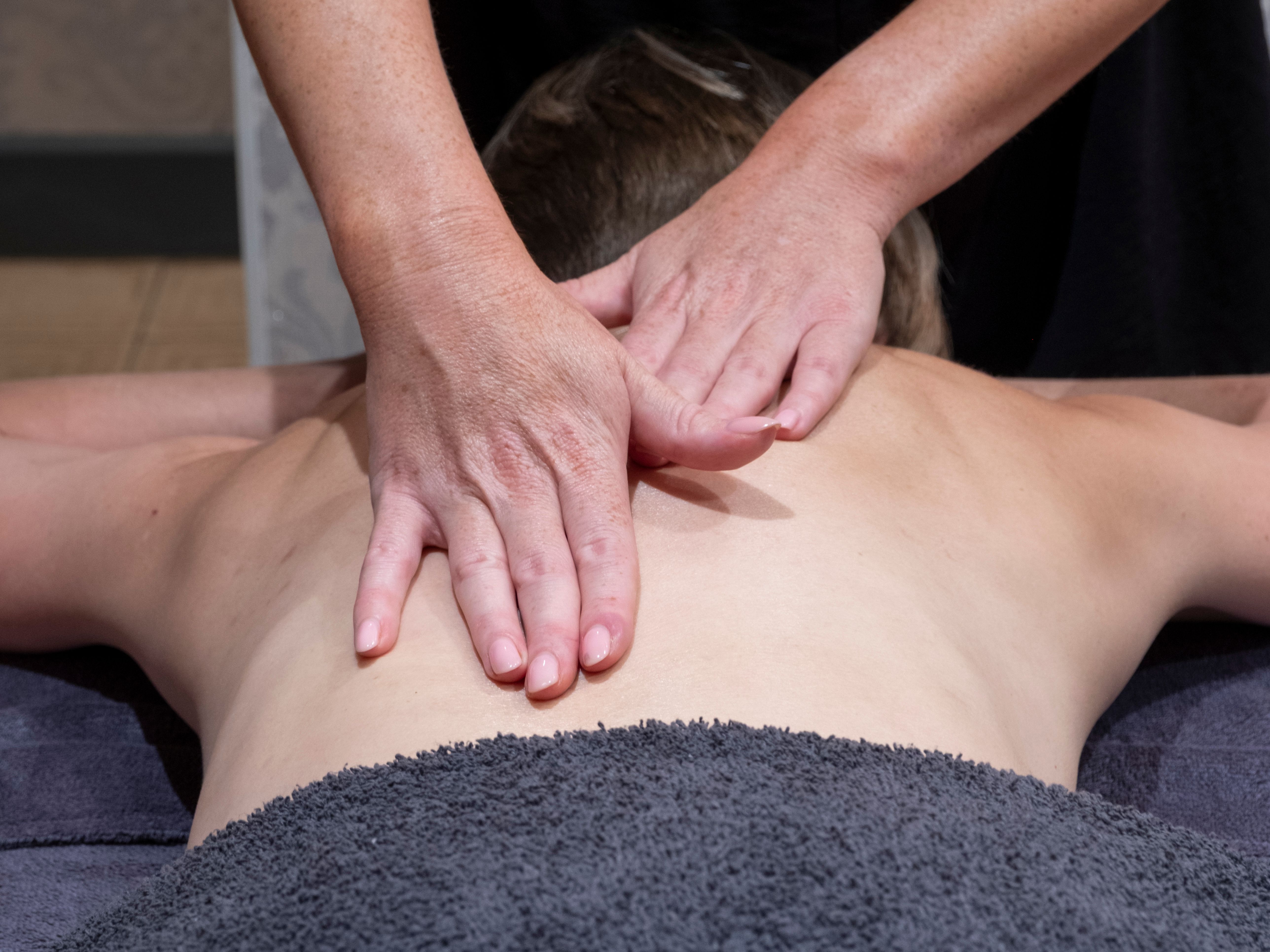 Person receiving a back massage from a massage therapist