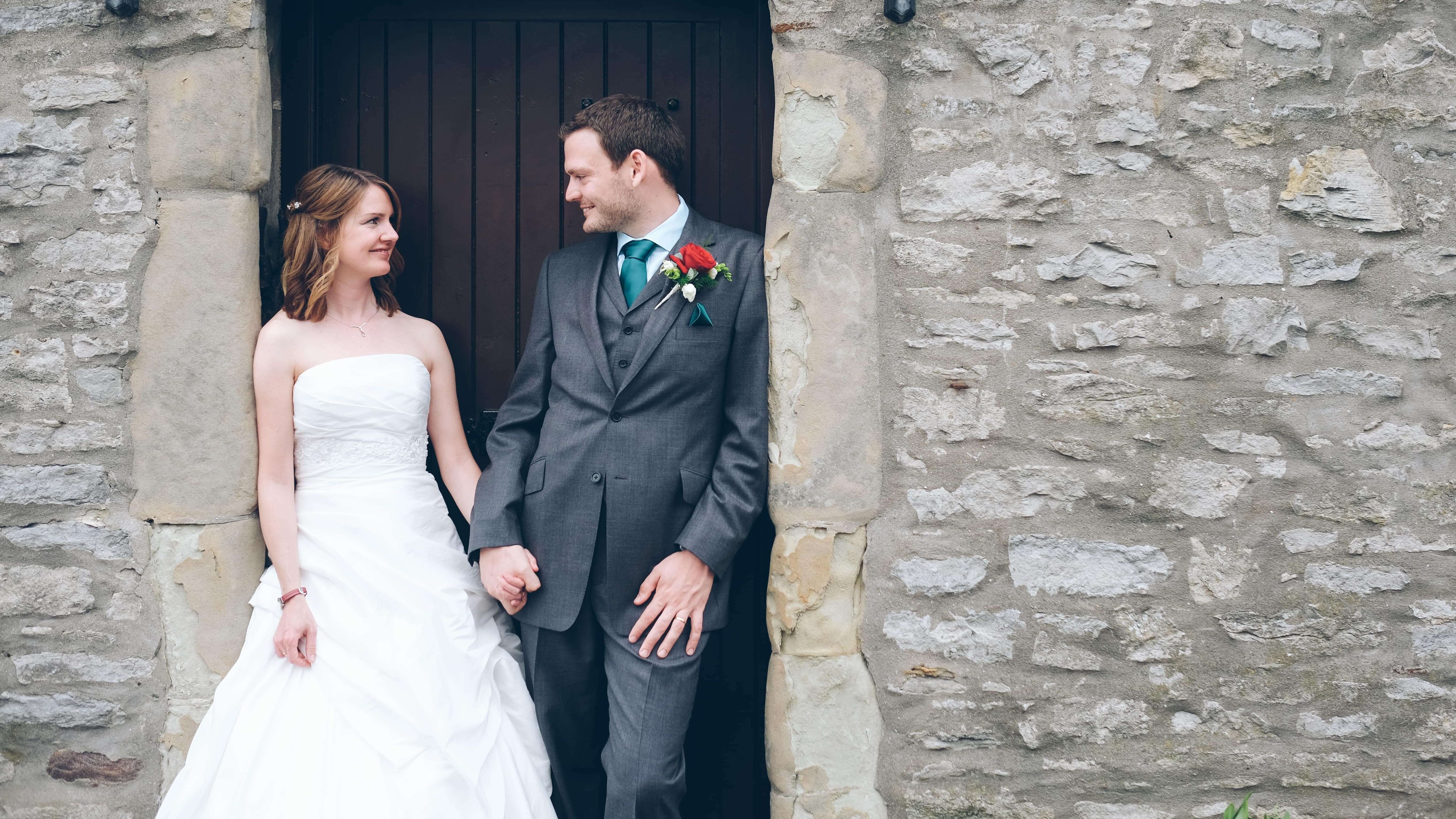 Bride and Groom Outside against Great House Building