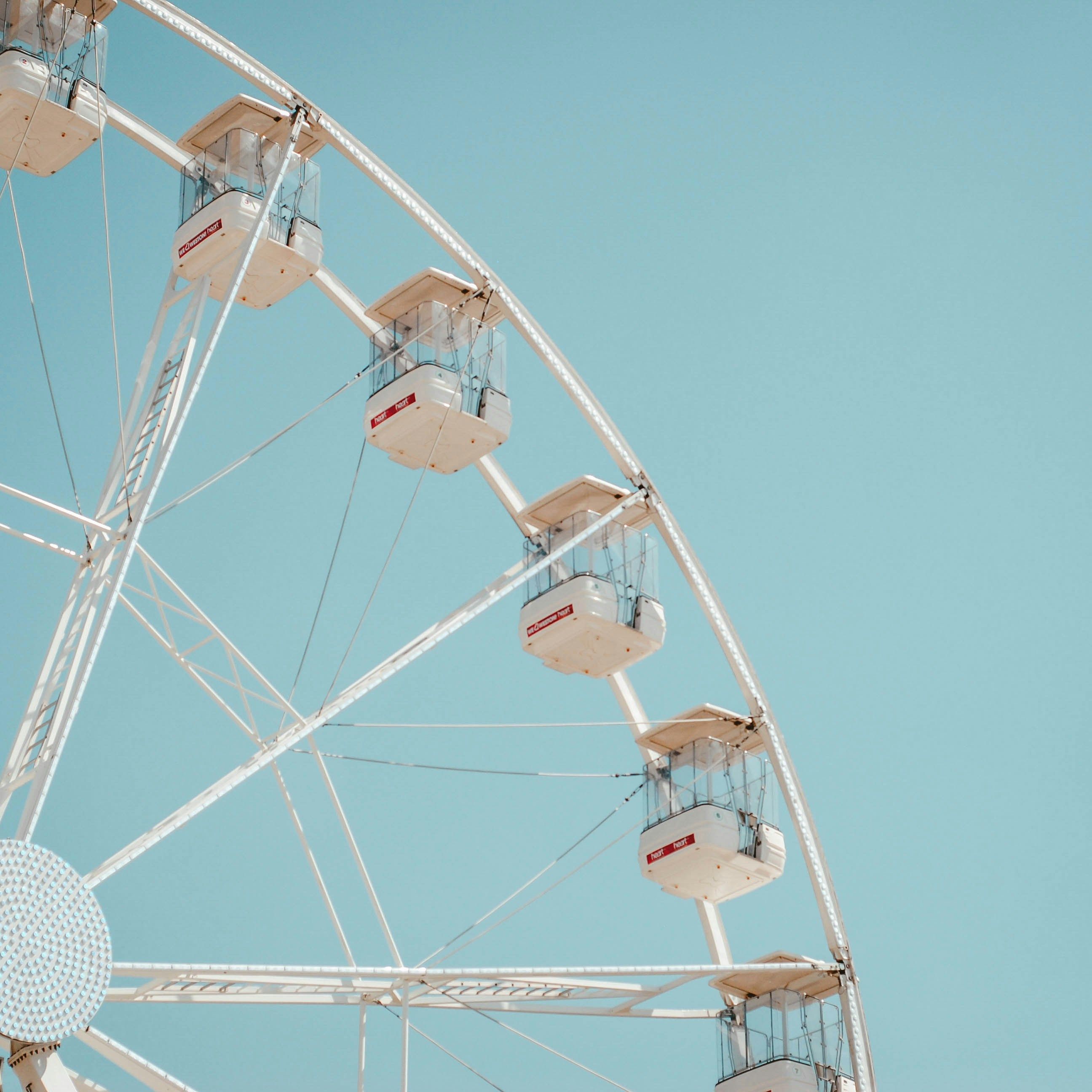 White Ferris wheel against a clear blue sky