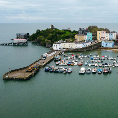 Aerial view of Tenby harbour with colourful waterfront houses and moored boats