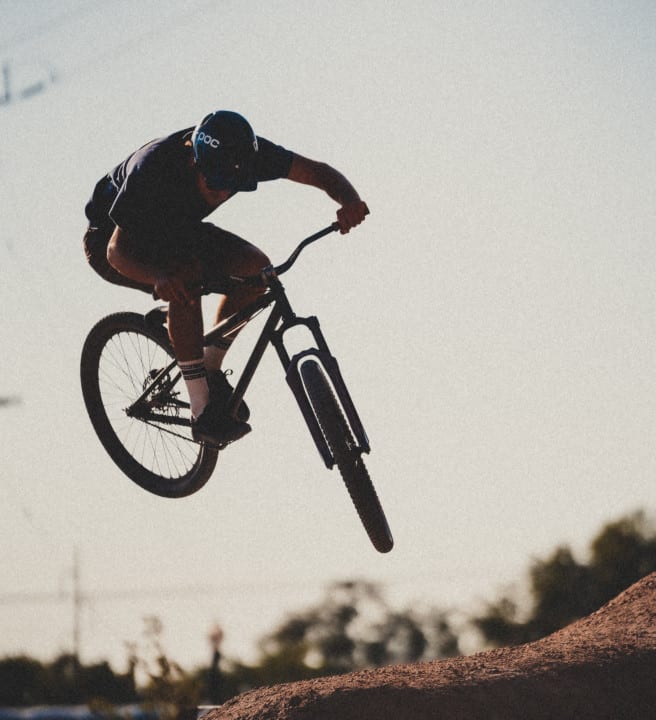 Person riding a BMX bike on a trail