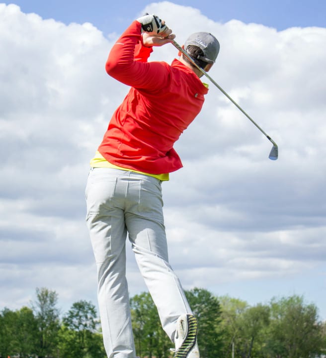 Man taking a swing to hit a golf ball