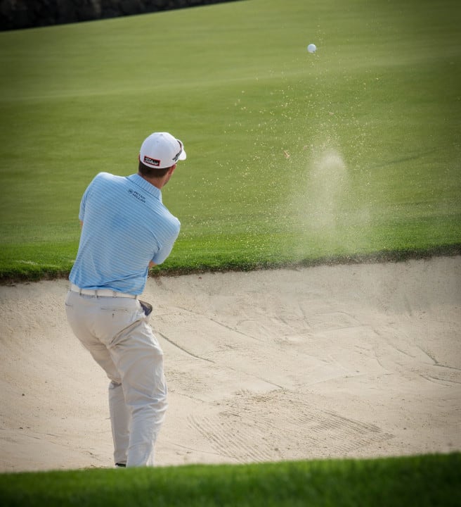 Person hitting a golf ball