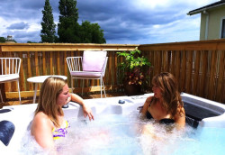 Two women in a holiday home with a hot tub
