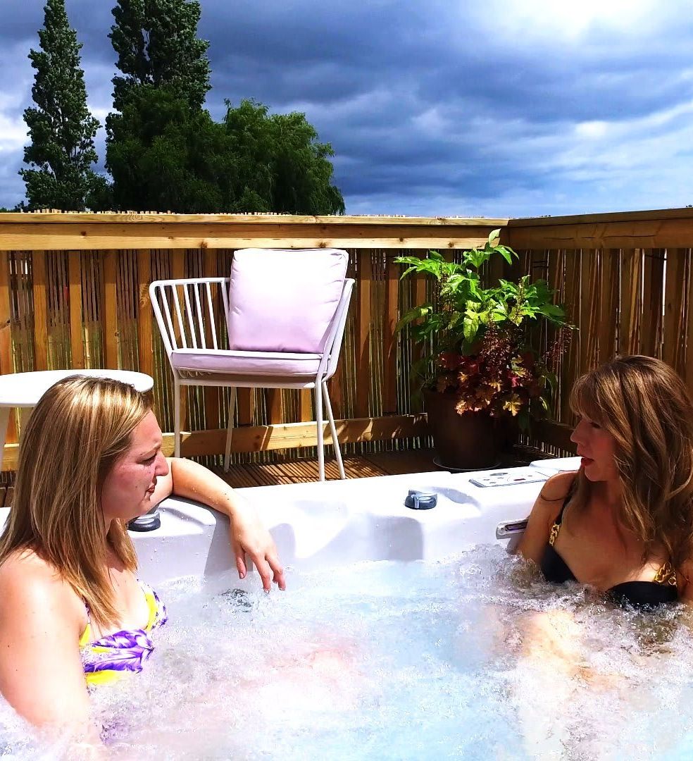 Two women in a holiday home with a hot tub