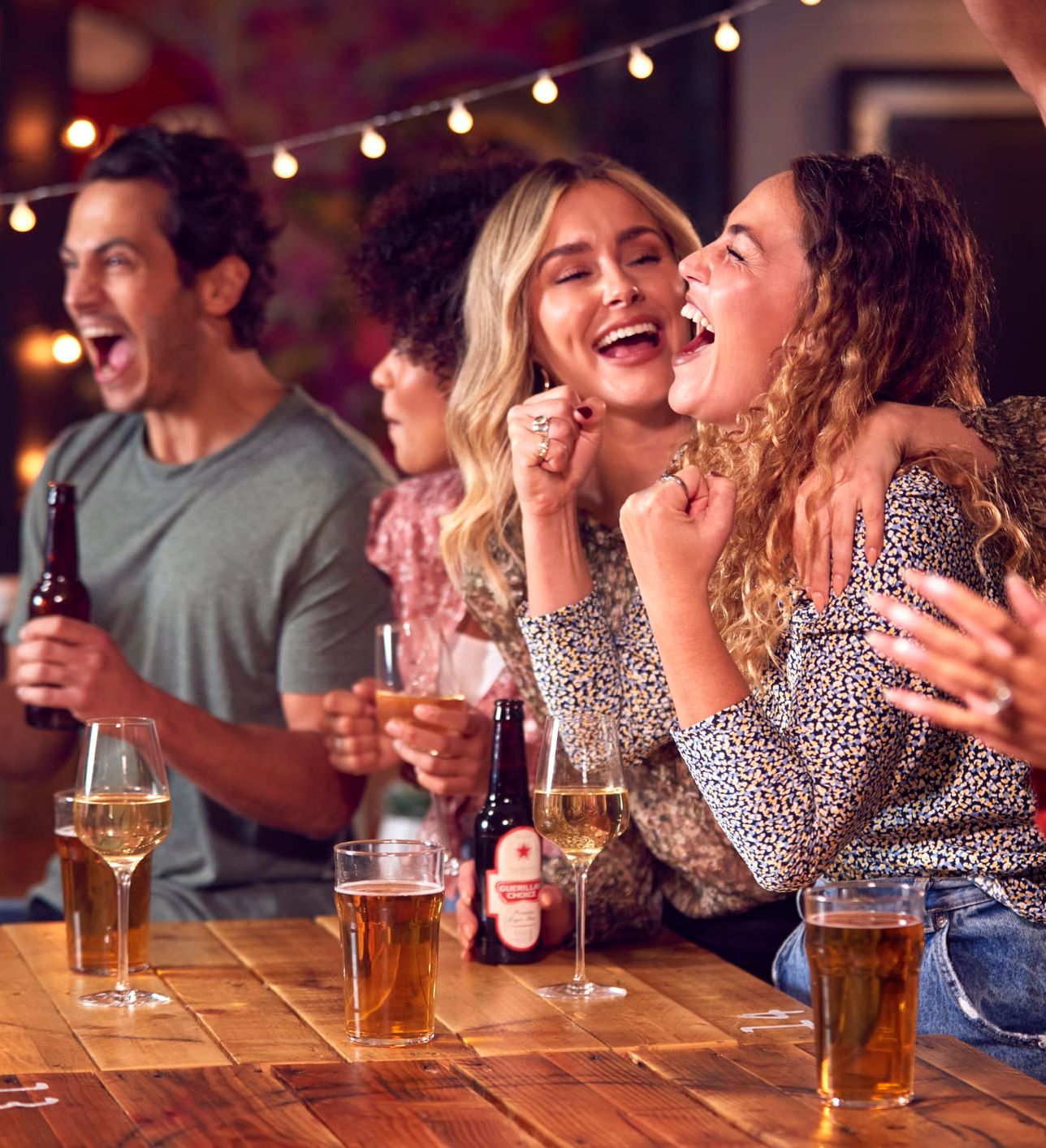 People smiling at a bar