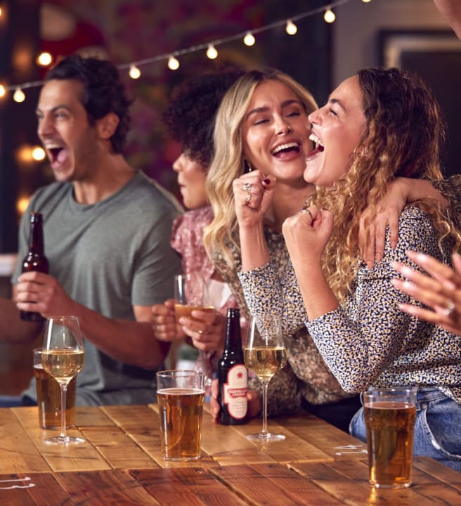People smiling at a bar