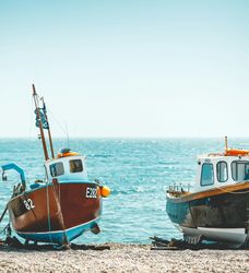 Two Boats on Devon Beach with Sea in background