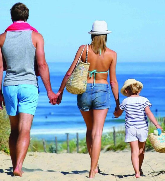 family walking on the beach