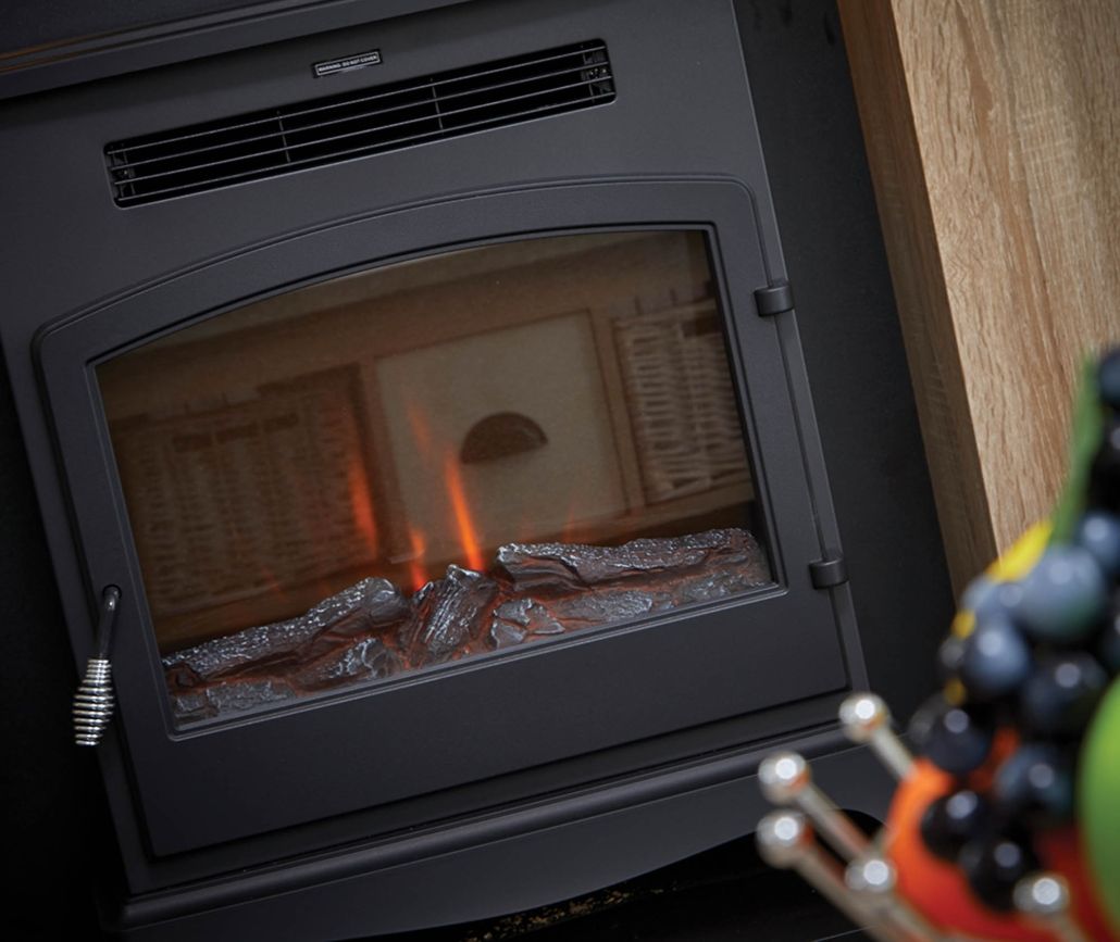Close-up of a black electric stove with glowing ember effect behind a glass door