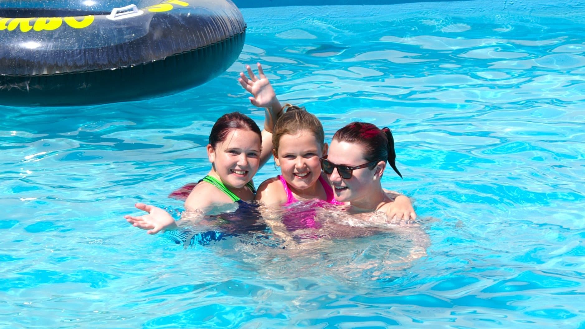 Family in an outdoor swimming pool