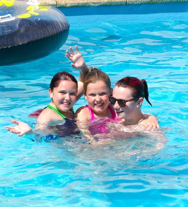 Family in an outdoor swimming pool