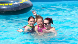 Family in an outdoor swimming pool