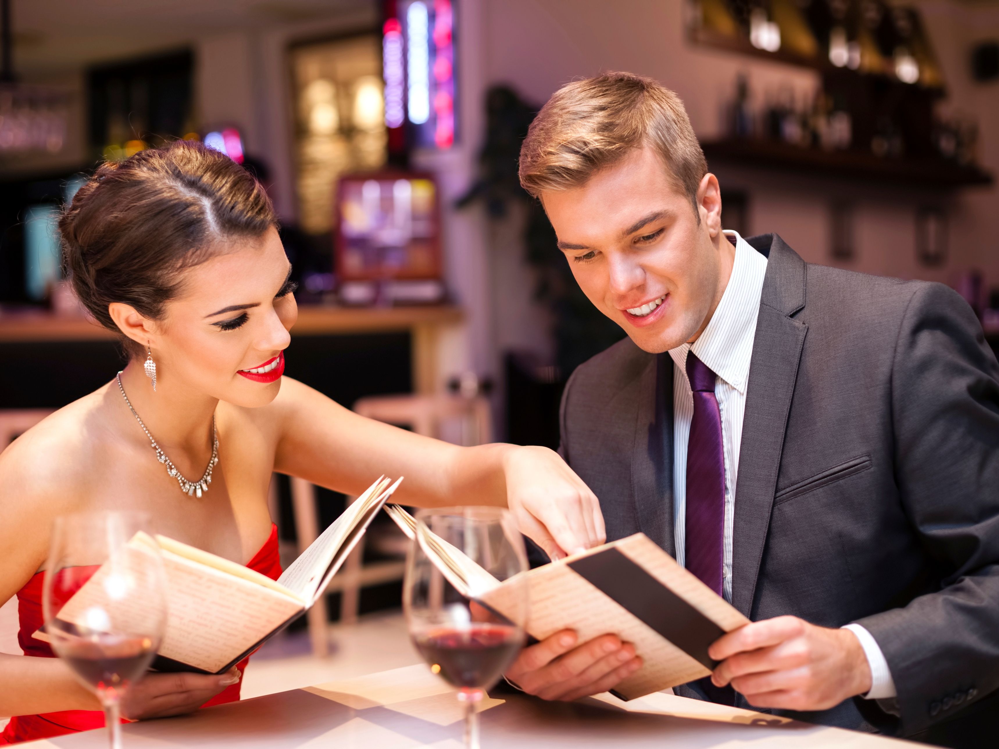 A couple looking at menus together in a restaurant