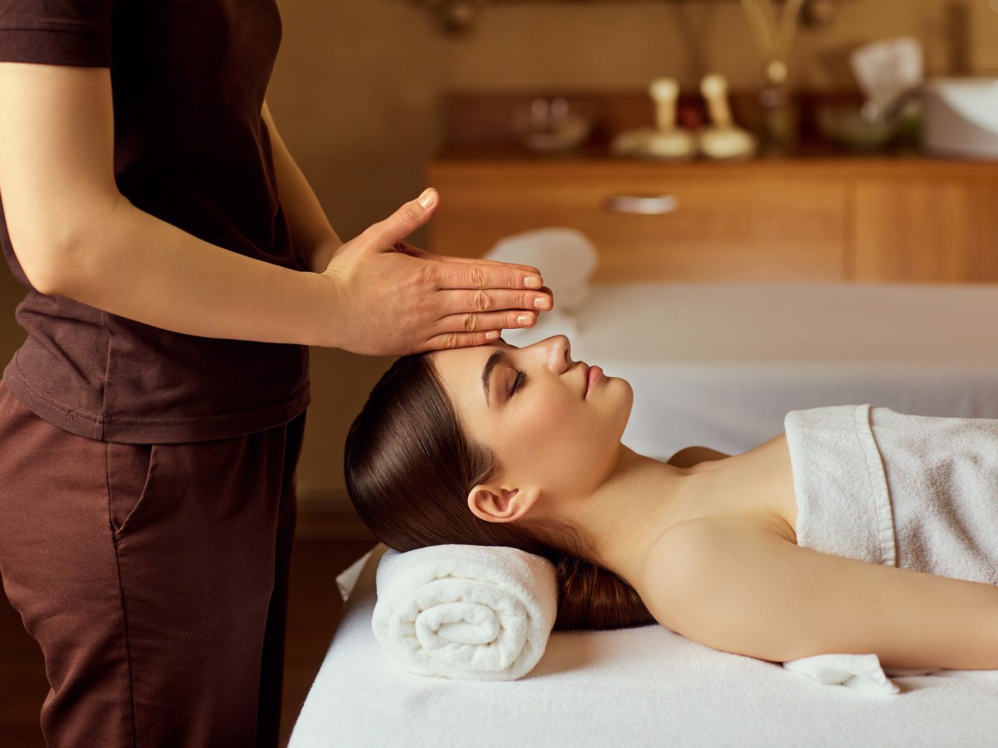 Woman receiving a forehead massage at a spa