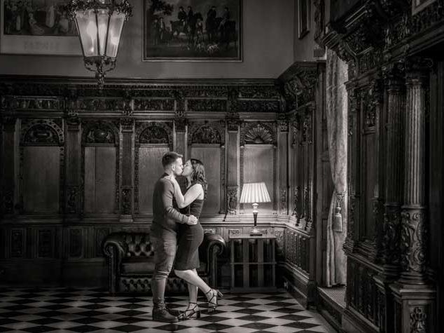 Couple kissing after a proposal in the Flemmish Hall