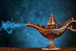 Ornate magic lamp with blue smoke emerging from the spout