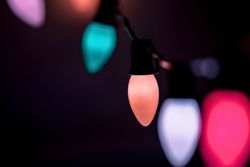 Close-up of colorful Christmas lights glowing in the dark