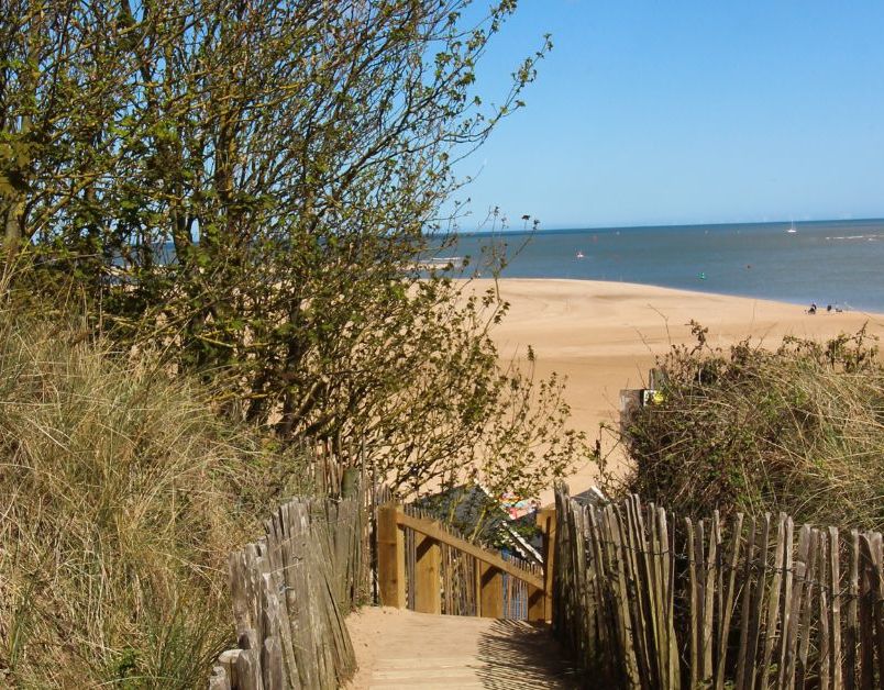 Wooden boardwalk through sand dunes leading to Holkham Beach on the Norfolk coast