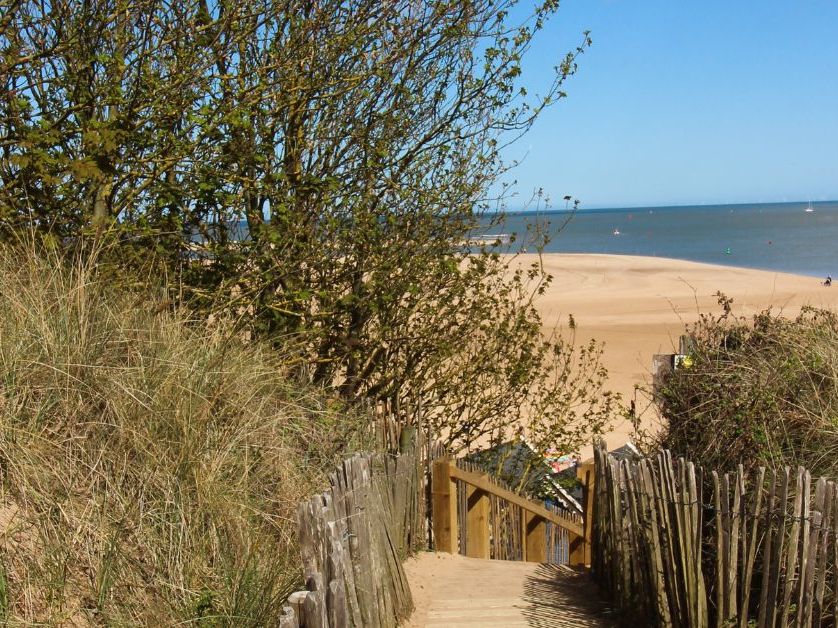 Wooden boardwalk through sand dunes leading to Holkham Beach on the Norfolk coast