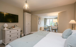 Luxury hotel room with a neutral colour palette and blue accents