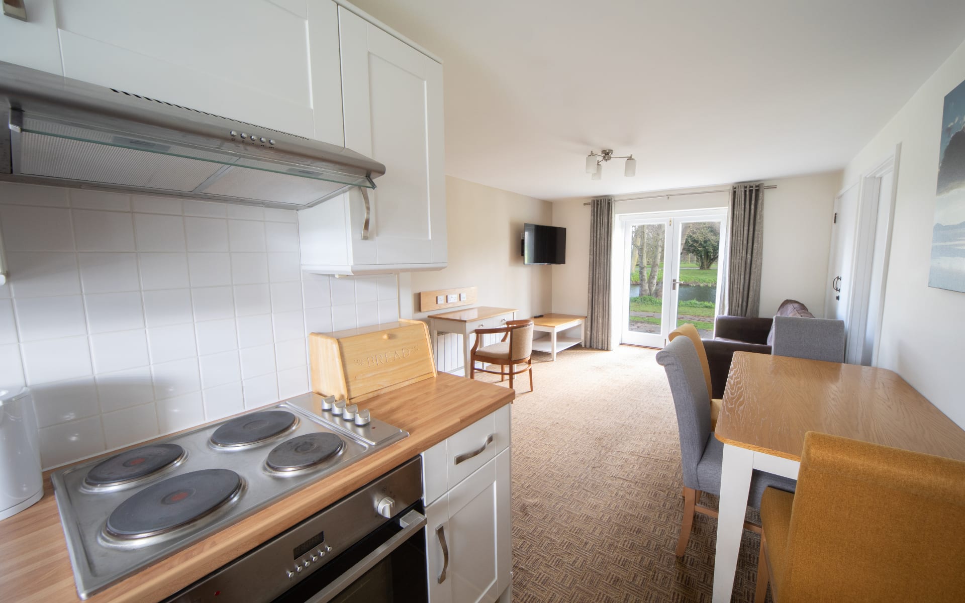 Kitchenette and living area with a patio door leading to duck pond.