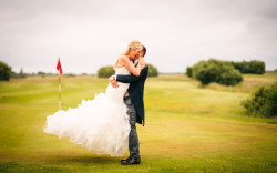 Couple embracing on Golf Course Mark Holmes Photography