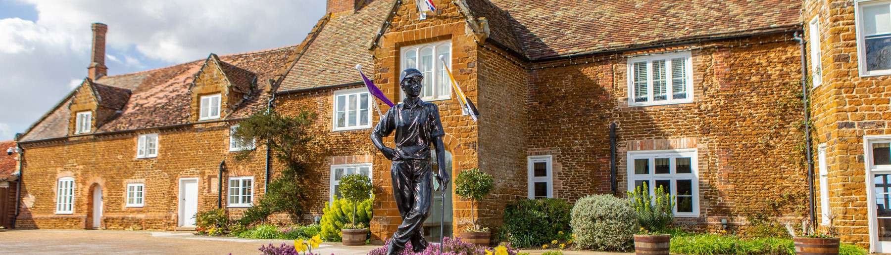 Wide Shot of Hotel Entrance with Golfer