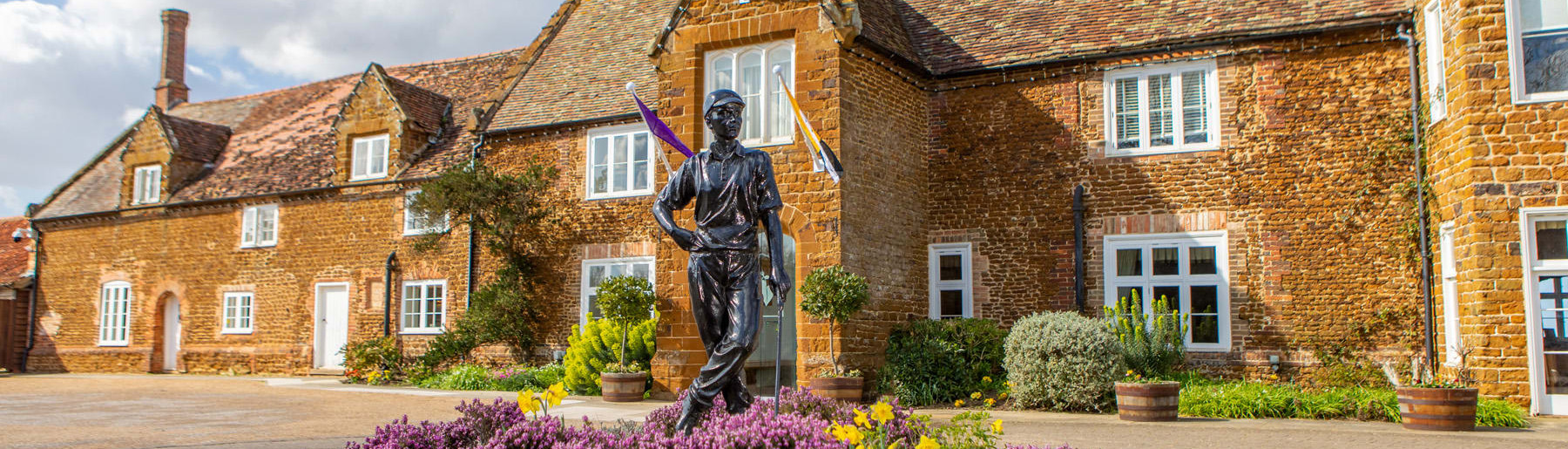 Wide Shot of Hotel Entrance with Golfer