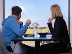 Couple dining in the Pavilion while enjoying the view across the golf course.