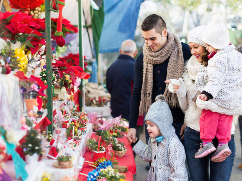 Family Looking at Christmas Gifts at fair