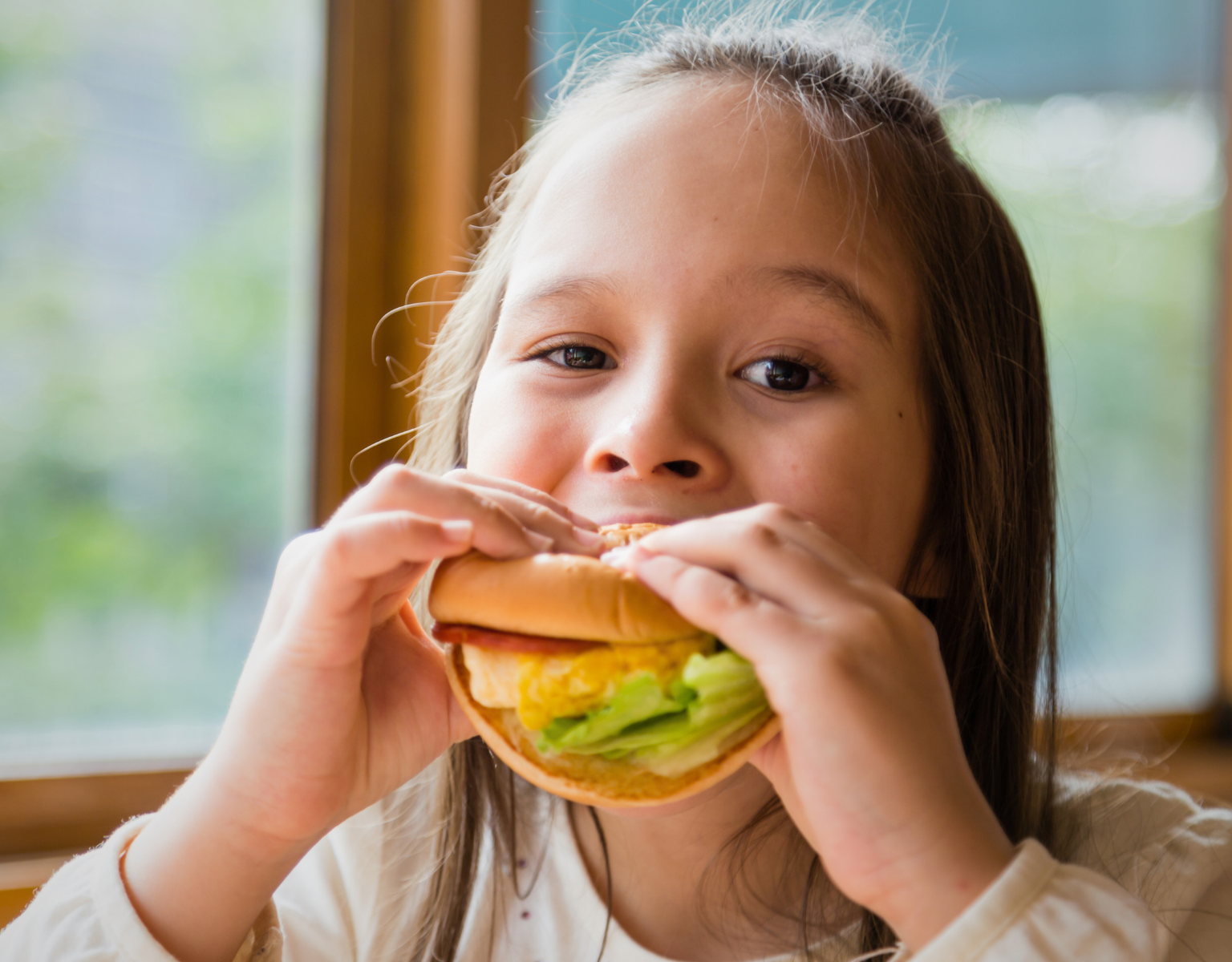 Young Girl Eating a Burger