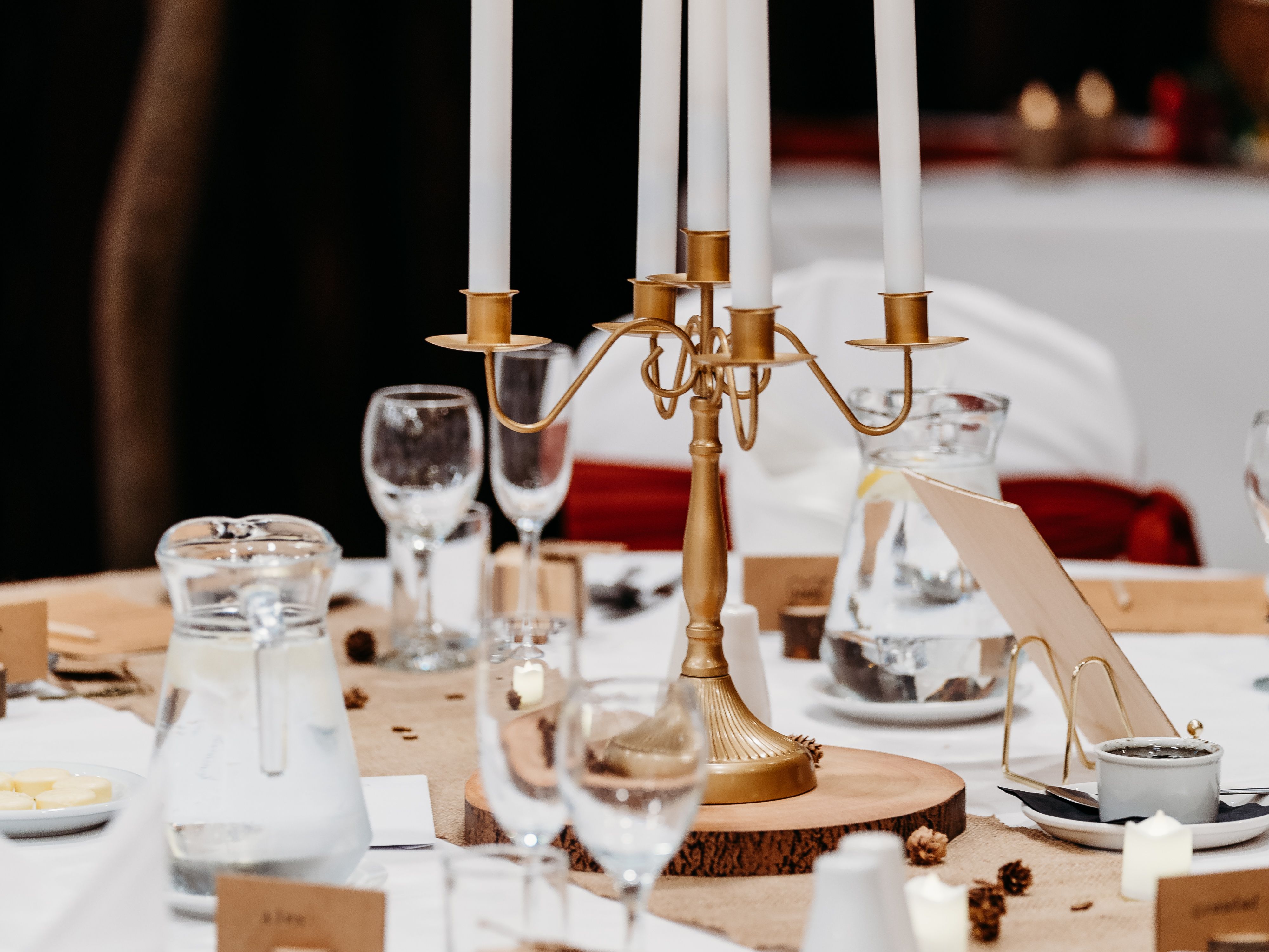 Elegant table setting with gold candelabra centerpiece and autumn decor