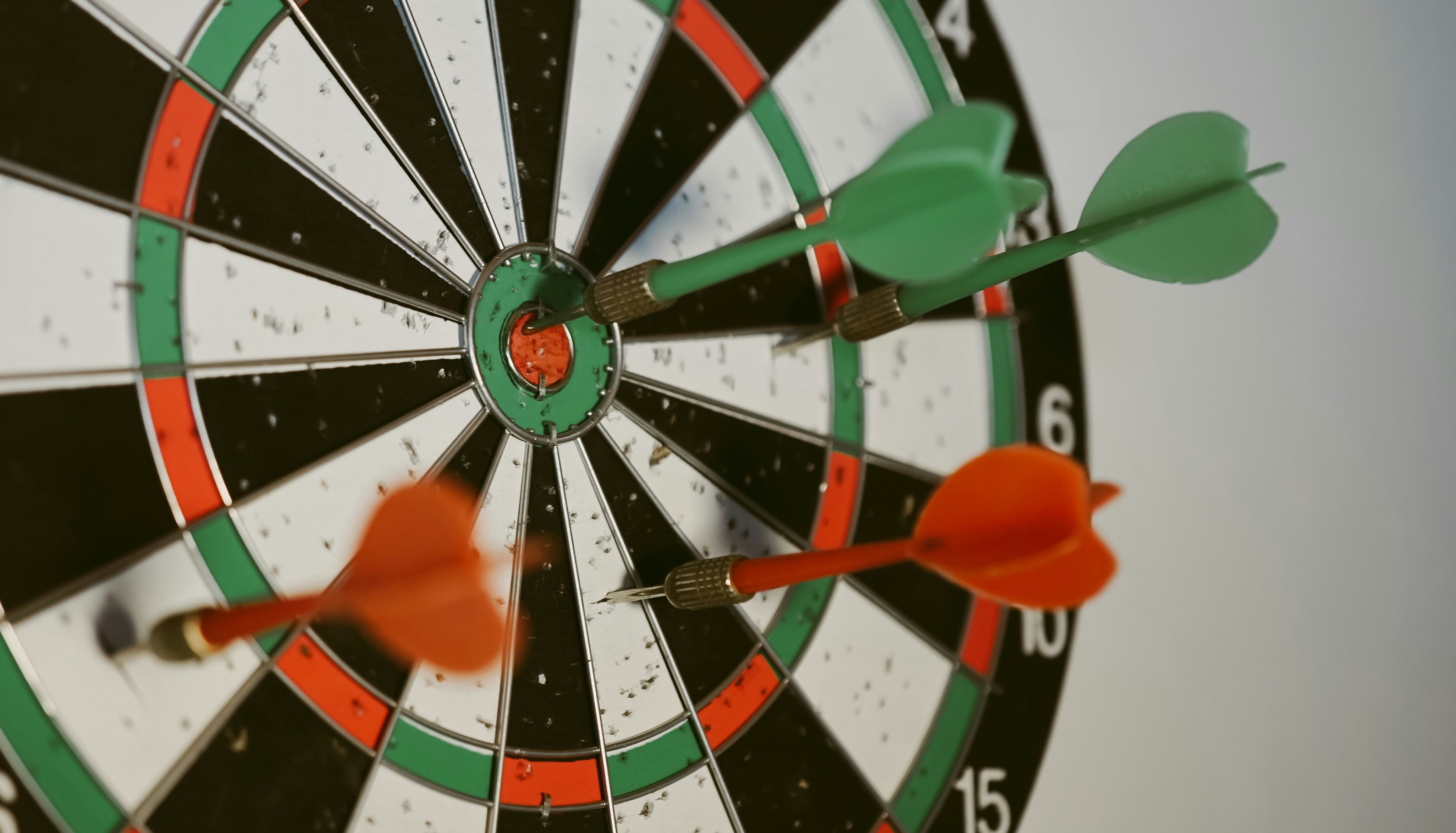Dartboard with darts hitting the bullseye