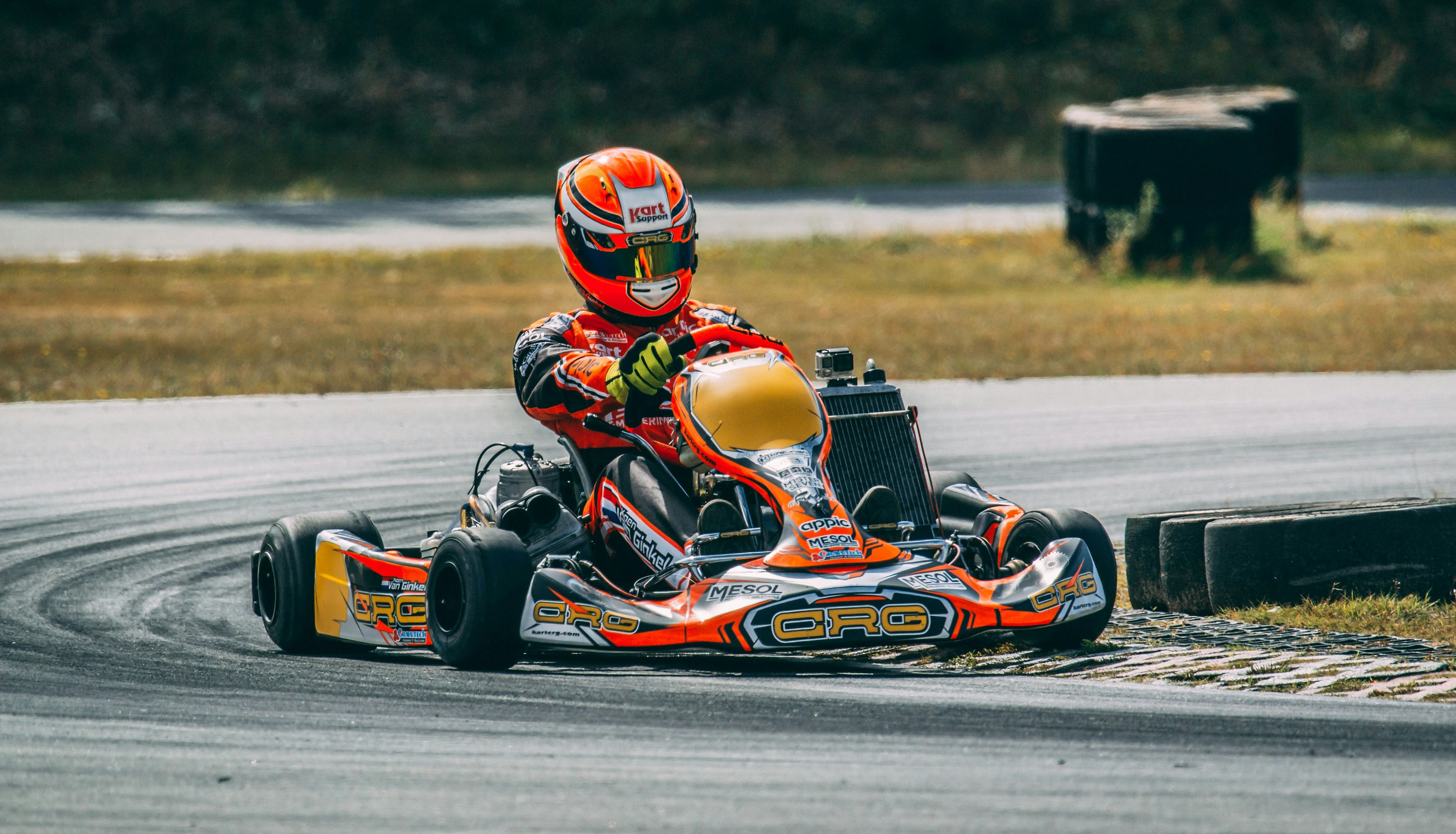 Go-kart racer making a turn on an outdoor track