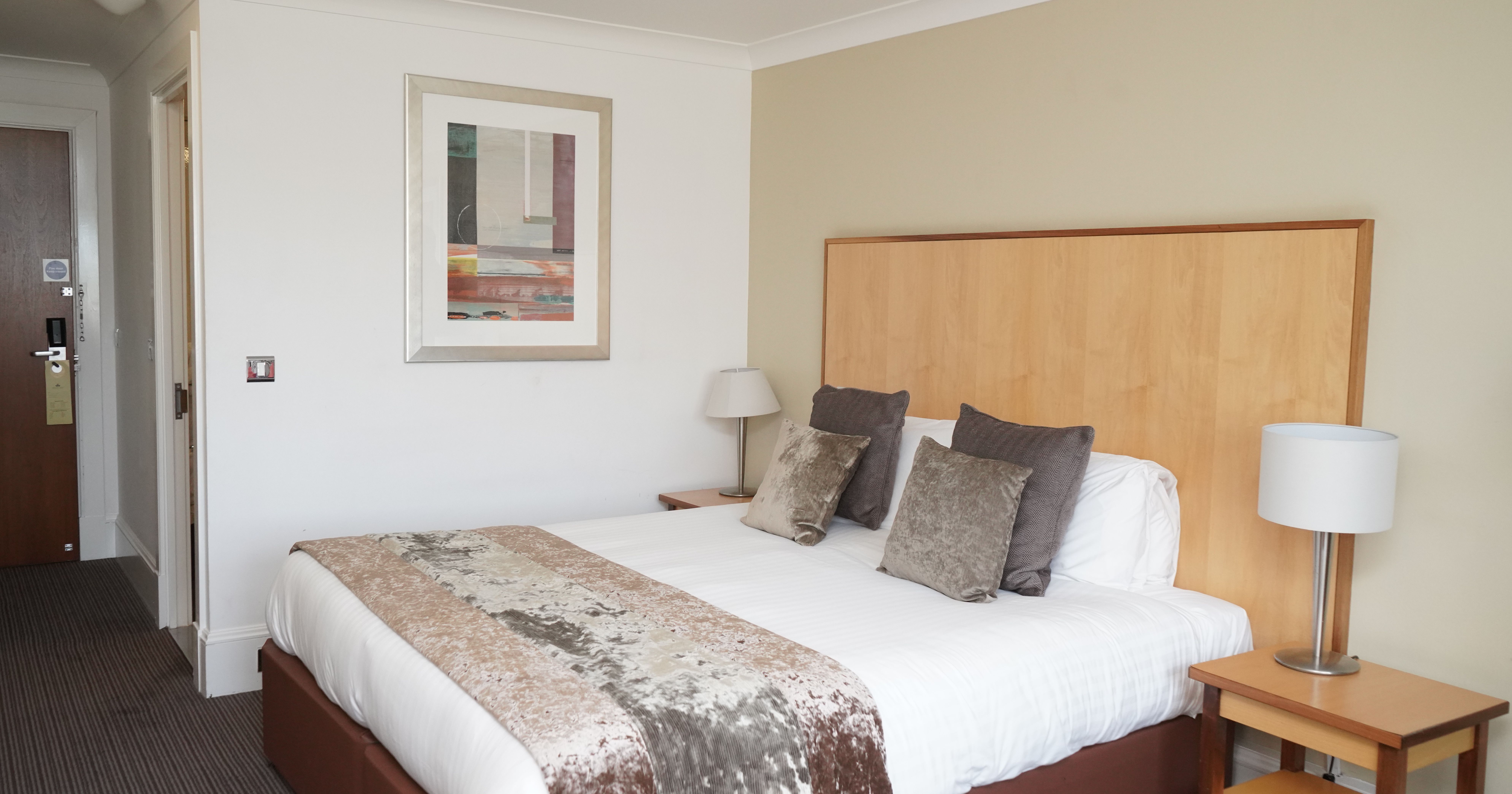 Modern hotel room with double bed and bedside tables