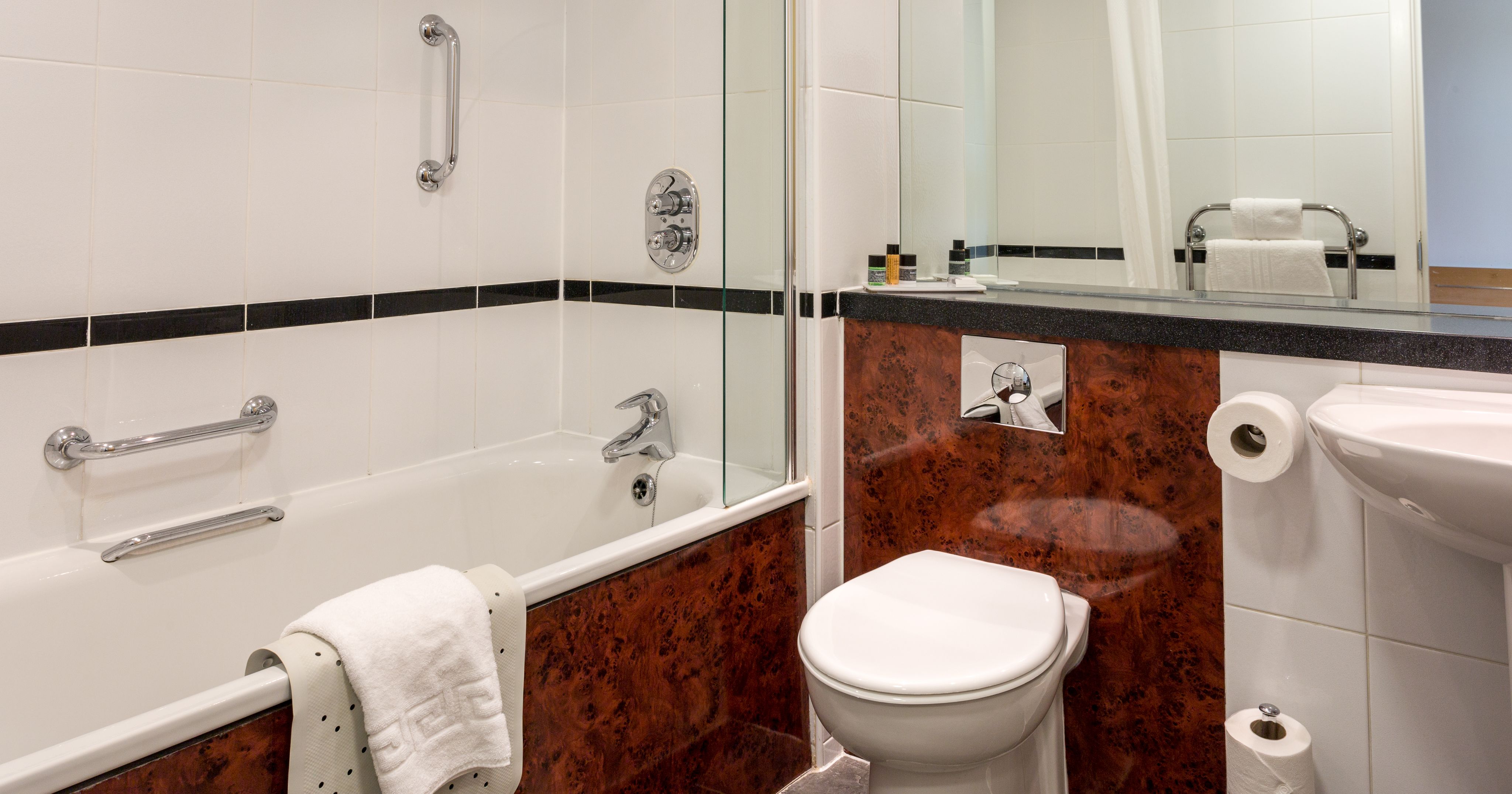 Modern bathroom with bathtub, toilet, and sink