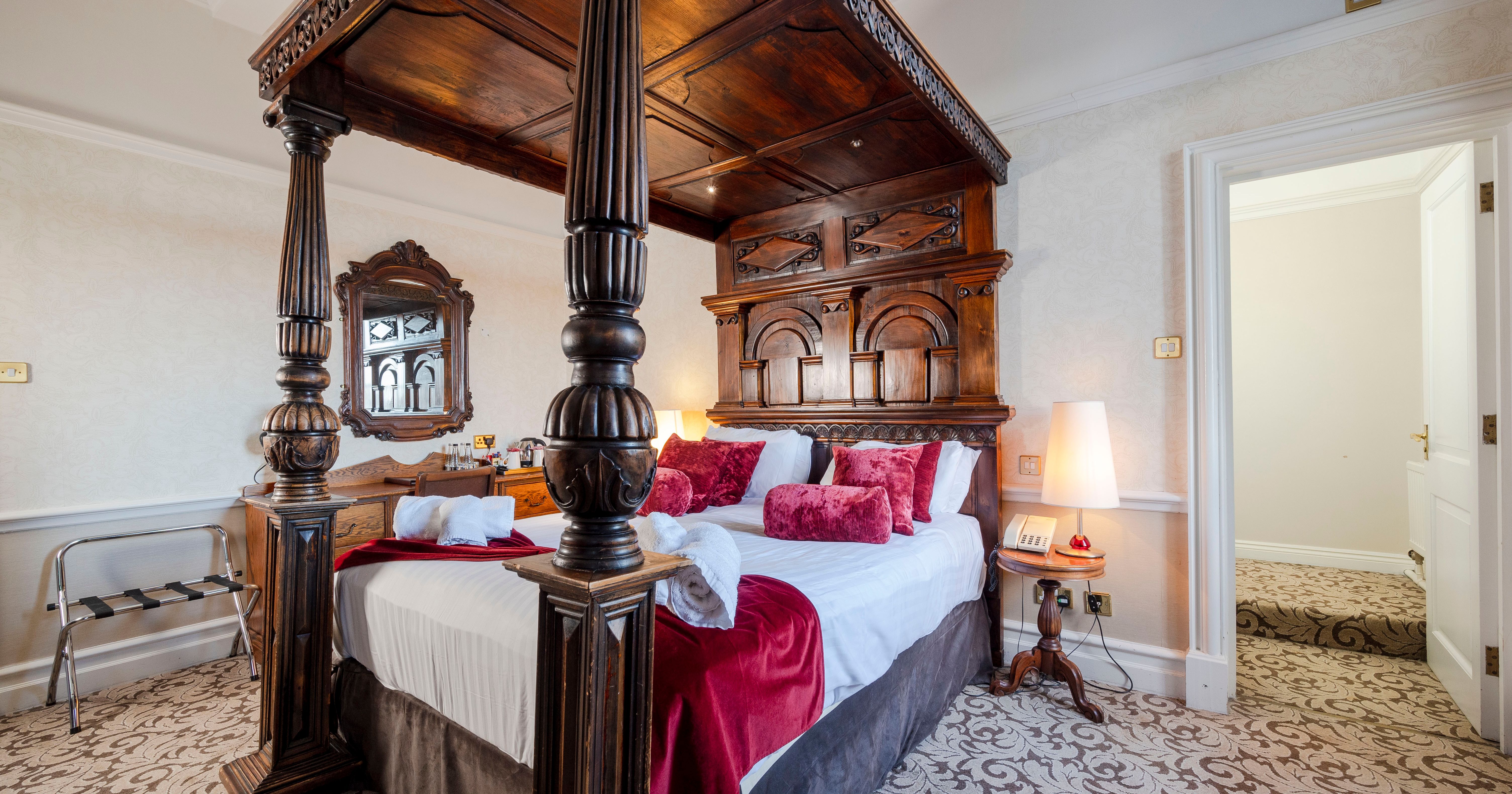Luxurious bedroom with ornate four-poster bed and vintage decor