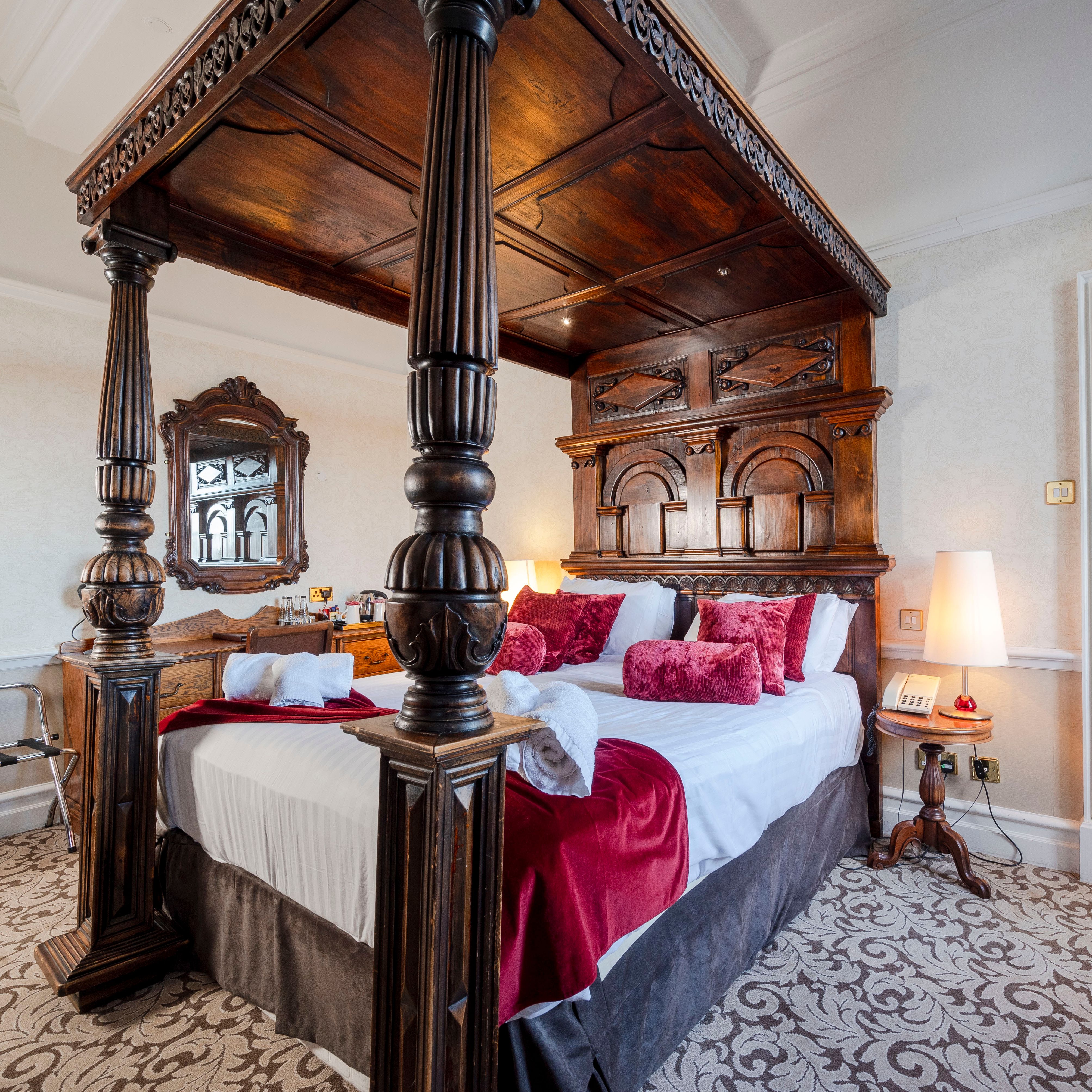 Luxurious bedroom with ornate four-poster bed and vintage decor