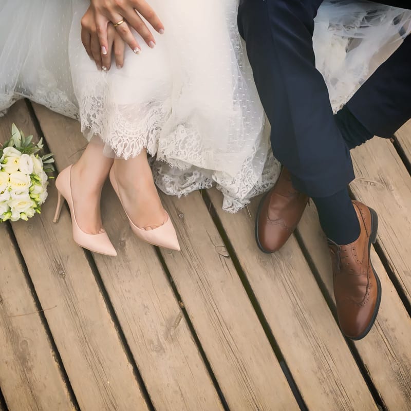 Bride and groom sat on a deck.